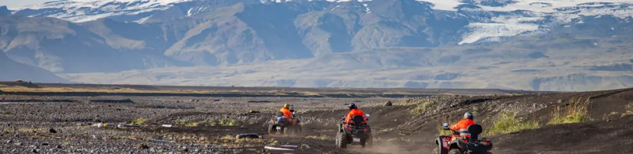 ATV riding on a black sand beach, Iceland.