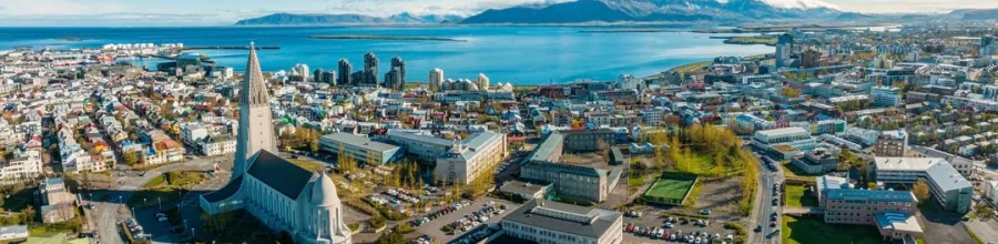  Aerial view of Reykjavik with Hallgrímskirkja and the ocean in the background.