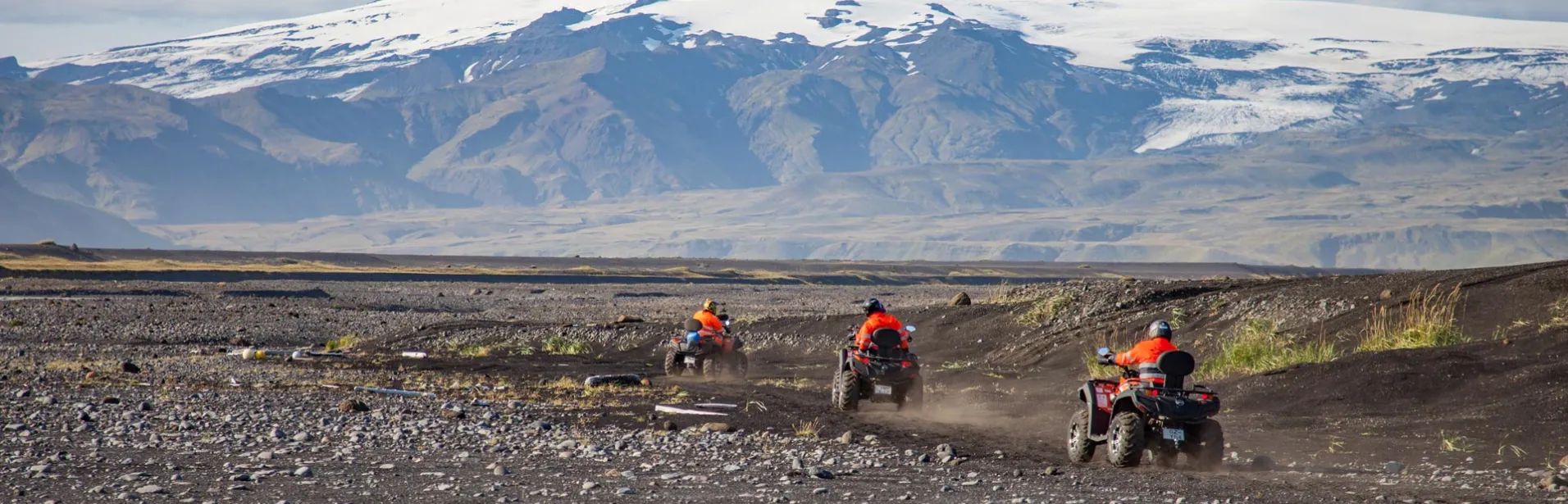 ATV riding on a black sand beach in Iceland.