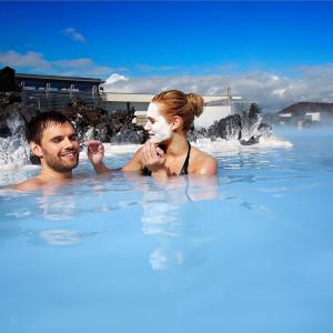 Reykjavik city break: couple relaxing at spa Blue Lagoon, south of Iceland.